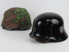 A reproduction German helmet with helmet cover size 57-58,