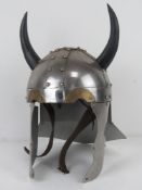 A reenactor or display medieval helmet having 'horns' upon.