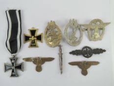 A quantity of assorted reproduction German badges and medals. Nine items.
