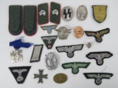 A quantity of assorted reproduction WWII German cloth patches, epaulettes, collar patches, etc.