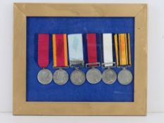 A framed medal grouping comprising six reproduction medals, Waterloo medal, Army of India Medal,