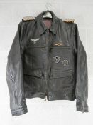 A repro WWII German Luftwaffe leather jacket (size 44) with awards and silk scarf.