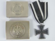 A quantity of reproduction militaria; 1x Russian Belt Buckle, 1x German Belt Buckle, 1x Iron cross.