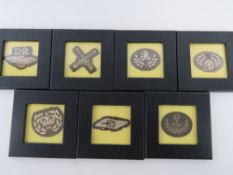A quantity of WWI British framed insignia, seven items.