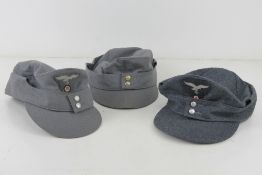 Three reproduction WWII German caps.