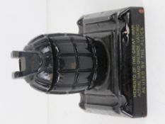 A smokers receptacle having inert WWI Grenade upon.