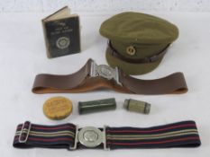 A quantity of British army personal equipment inc peak cap, first aid book, two belts,