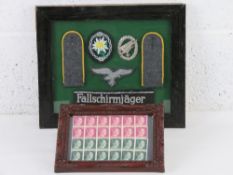 A reproduction WWII German armband. Framed WWII Hitler Stamps (24 stamps).