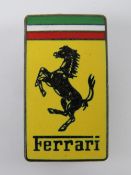 An enamel Ferrari pin badge.