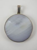 A mother of pearl and silver pendant of