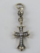 A silver Crucifix pendant set with white