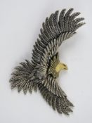 A silver pendant in the form of an eagle