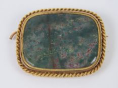 A blood stone agate brooch, gilt metal setting, pin a/f, no apparent hallmarks, 3.1cm wide.