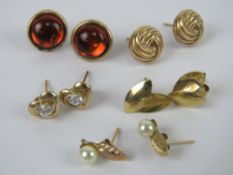 Five pairs of yellow metal stud earrings including a pair of 9ct gold leaf earrings, hallmarked 375.