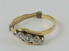 An 18ct gold ring having illusion set diamonds to the wrap style setting in white metal,