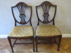 A good pair of Hepplewhite style shield back mahogany dining chairs, each with drop in seat.