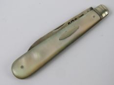 An HM silver and Mother of Pearl fruit knife, hallmarked Sheffield and measuring 12cm when open.