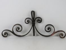 A piece of iron scrollwork for the top of a gate.