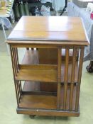 An Edwardian revolving Canterbury bookcase 62 x 62 x 91cm.