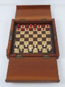 A Whittington style portable chess set with red stained and natural bone pieces, board 22.