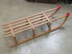 A wooden toboggan by Gloco West Germany measuring 109.5cm in length.
