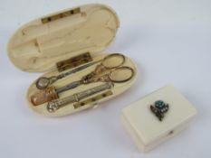A late Victorian ivory etui opening to reveal gilt metal thimble, scissors (a/f),