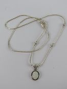 A 925 silver and opal pendant of oval form on a Native American style beaded chain.