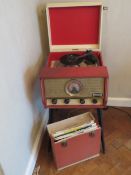 An original 1960s Dansette record player raised over slanted tapering legs,