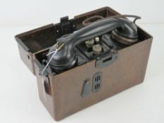 A 1937 field telephone in bakelite case having German military marks to handset.