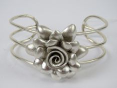 A floral bangle stamped 925, 38.1g.