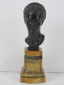 A bronze bust of a woman with elaborately braided hair after an antique model,