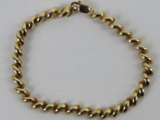 A 10ct gold bracelet having spiral design and measuring 18cm in length, stamped 10Kt and weighing 4.