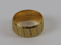 An 18ct gold wide band ring, hallmarked for Birmingham, size N-O, 6.4g.