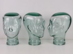Three heavy glass 'mannequin' display heads, approx 30cm high.