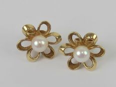 A pair of 9ct gold and pearl floral stud earrings, hallmarked 375, with butterfly backs, 2.3g.