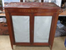 A good early 20th century Oriental two door cabinet profusely decorated with raised and gilded