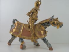 A handmade terracotta figure of a medieval knight on horseback, a/f, approx 58cm high.