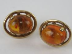 A pair of 9ct gold and Baltic amber earrings, hallmarked 375, with butterfly backs, 1.1cm wide.