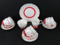 A six setting tea service having trios milk jug, sugar bowl and cake plate.
