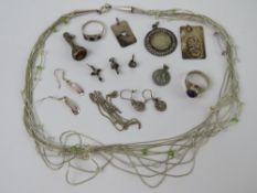 A quantity of assorted silver and white metal jewellery including; rings, coin pendant,