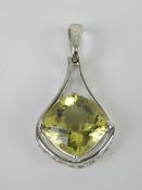 A large silver and citrine pendant of teardrop form,