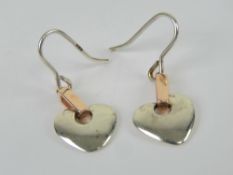 A pair of Clogau gold and silver Cariad earrings.