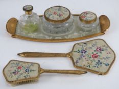 A mid-20thC dressing table set comprising perfume bottle, pots, tray, hairbrush and mirror.