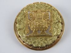 An 18ct gold brooch/pendant of 'Aztec' design featuring central god, stamped 18K to the back,