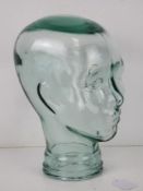 A heavy glass 'mannequin' display head, approx 30cm high.