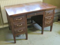 A c1930s mahogany rigid kneehole desk,