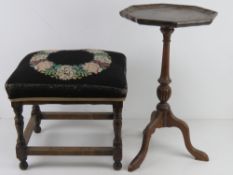 A mahogany wine table raised over tripod feet, together with a four legged embroidery footstool.