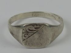 A silver signet ring, no monogram, scroll design engraving to upper left, stamped sil, size W.