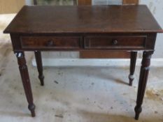A 19th century twin drawer side table raised over reeded legs, 94 x 47 x 75cm.