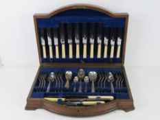 A quantity of silver plated and stainless steel cutlery inc carving set contained within oak